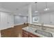 Basement kitchenette featuring granite countertops, tile backsplash, and an undermounted stainless steel sink at 644 Angelica Cir, Cary, NC 27518