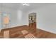 Bright living room with hardwood flooring, white walls, and an open archway to the kitchen at 644 Angelica Cir, Cary, NC 27518