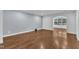 Large living room featuring wood floors, neutral walls, and access to an adjacent sunroom at 644 Angelica Cir, Cary, NC 27518
