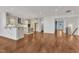 Expansive living space with hardwood floors, kitchen with island, and views of the front door at 644 Angelica Cir, Cary, NC 27518