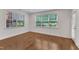 Bright room with two large windows, hardwood floors, and white trim, offering a welcoming atmosphere at 644 Angelica Cir, Cary, NC 27518