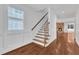 Elegant staircase with hardwood treads, white risers, and decorative iron railing at 644 Angelica Cir, Cary, NC 27518