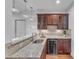 Wet bar featuring granite countertops, custom cabinetry, a wine fridge and pendant lighting at 644 Angelica Cir, Cary, NC 27518