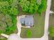 Aerial view of a well-maintained home with a concrete driveway and lush green lawn in a wooded neighborhood at 6509 Duncans Creek Ct, Fuquay Varina, NC 27526