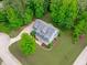 A charming, light-blue home is surrounded by lush greenery and well-manicured landscaping at 6509 Duncans Creek Ct, Fuquay Varina, NC 27526