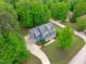Aerial view of a stunning two-story home with a long driveway and mature trees at 6509 Duncans Creek Ct, Fuquay Varina, NC 27526