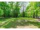 Expansive backyard with lush greenery and mature trees at 6509 Duncans Creek Ct, Fuquay Varina, NC 27526