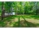 Mature trees and a large green lawn define this spacious backyard at 6509 Duncans Creek Ct, Fuquay Varina, NC 27526