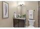 Stylish half bathroom with modern fixtures, granite countertop, and decorative accents at 6509 Duncans Creek Ct, Fuquay Varina, NC 27526