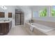 Well-lit bathroom features a tub, shower, and dual vanity at 6509 Duncans Creek Ct, Fuquay Varina, NC 27526
