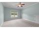 Bright bedroom features a ceiling fan and large window at 6509 Duncans Creek Ct, Fuquay Varina, NC 27526
