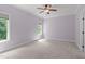 A carpeted bedroom showcasing two windows at 6509 Duncans Creek Ct, Fuquay Varina, NC 27526