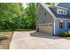 Long driveway leading to a garage, with a basketball hoop, and a spacious backyard at 6509 Duncans Creek Ct, Fuquay Varina, NC 27526