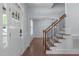 Welcoming foyer with hardwood floors, staircase, and views of the dining room at 6509 Duncans Creek Ct, Fuquay Varina, NC 27526