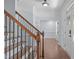 Elegant foyer featuring a staircase with hardwood treads and iron spindles, and gleaming wood floors at 6509 Duncans Creek Ct, Fuquay Varina, NC 27526