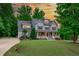 Beautiful two-story home featuring a manicured front lawn and a welcoming covered porch with an American flag at 6509 Duncans Creek Ct, Fuquay Varina, NC 27526
