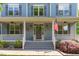 Charming front porch with an American flag waving, creating a patriotic welcome at 6509 Duncans Creek Ct, Fuquay Varina, NC 27526