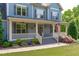 Inviting front porch with fans, American flag, and lovely landscaping creating curb appeal at 6509 Duncans Creek Ct, Fuquay Varina, NC 27526