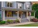 Inviting front porch featuring a welcoming entrance, stylish decor, and well-maintained landscaping at 6509 Duncans Creek Ct, Fuquay Varina, NC 27526