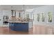 Bright kitchen featuring granite counters, stainless appliances, custom cabinets, and an island with breakfast bar at 6509 Duncans Creek Ct, Fuquay Varina, NC 27526