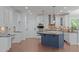 Modern kitchen featuring white cabinets, a blue island, granite countertops, and new appliances at 6509 Duncans Creek Ct, Fuquay Varina, NC 27526