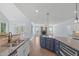 Open-concept kitchen with stainless steel sink, stone countertops, and island overlooking the living room at 6509 Duncans Creek Ct, Fuquay Varina, NC 27526