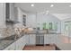 Open kitchen featuring stainless steel appliances, granite counters, and custom cabinets at 6509 Duncans Creek Ct, Fuquay Varina, NC 27526