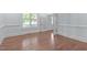 Bright living room features natural light, wood flooring, and neutral paint at 6509 Duncans Creek Ct, Fuquay Varina, NC 27526