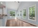 Bright living room bathed in natural light through many windows with hardwood floors at 6509 Duncans Creek Ct, Fuquay Varina, NC 27526