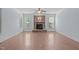 Inviting living room with hardwood floors, a stone fireplace, and natural light at 6509 Duncans Creek Ct, Fuquay Varina, NC 27526