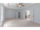 Large primary bedroom boasts tray ceiling and many doors at 6509 Duncans Creek Ct, Fuquay Varina, NC 27526