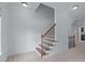 Elegant staircase with wooden banister and iron spindles adds charm to the home at 6509 Duncans Creek Ct, Fuquay Varina, NC 27526