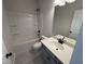 Clean bathroom featuring sleek gray vanity, modern fixtures, and a tub and shower combo for convenience at 67 Commons Cir, Clayton, NC 27520