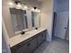 Bathroom featuring double vanity with undermount sinks, sleek mirrors, and modern fixtures for a spa-like experience at 67 Commons Cir, Clayton, NC 27520