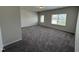 Spacious bedroom with soft, neutral walls and carpeted floors, flooded with natural light at 67 Commons Cir, Clayton, NC 27520