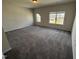 Large bedroom with plush carpet, neutral walls, and natural light, offering a comfortable living space at 67 Commons Cir, Clayton, NC 27520