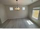 Dining area with modern chandelier, wood-look flooring, and natural light at 67 Commons Cir, Clayton, NC 27520