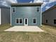 Exterior of home featuring a concrete patio, back door, and multiple windows at 67 Commons Cir, Clayton, NC 27520