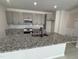 Modern kitchen featuring an island with a sink, granite countertops, and stainless steel appliances at 67 Commons Cir, Clayton, NC 27520