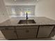 Spacious kitchen island with granite countertops overlooking a light-filled living area at 67 Commons Cir, Clayton, NC 27520
