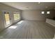 Bright and airy living room featuring wood-look floors, ample natural light, and an open layout at 67 Commons Cir, Clayton, NC 27520