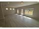 Spacious open-concept living space with wood-look floors, a door to backyard, and plenty of natural light at 67 Commons Cir, Clayton, NC 27520