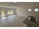 Open concept living room showcasing a kitchen island, modern lighting, and access to the backyard at 67 Commons Cir, Clayton, NC 27520