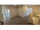 Upstairs loft area with neutral walls and soft carpet, creating a versatile and comfortable space at 67 Commons Cir, Clayton, NC 27520