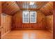 Charming attic with natural light, wood paneled walls, and crisp white window trim at 701 E Nash St, Spring Hope, NC 27882