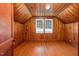 Attic room with knotty pine wood paneling, wood floors, and a dormer window at 701 E Nash St, Spring Hope, NC 27882