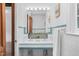 Bathroom with double sinks, a large mirror, and bright lighting fixtures at 701 E Nash St, Spring Hope, NC 27882