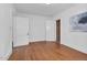 Spacious bedroom featuring hardwood floors, white walls, and multiple doorways at 701 E Nash St, Spring Hope, NC 27882