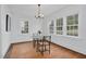Dining room with bright natural light, chandelier, and hardwood floors at 701 E Nash St, Spring Hope, NC 27882