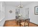 Bright dining room with hardwood floors and a glass table illuminated by chandelier at 701 E Nash St, Spring Hope, NC 27882